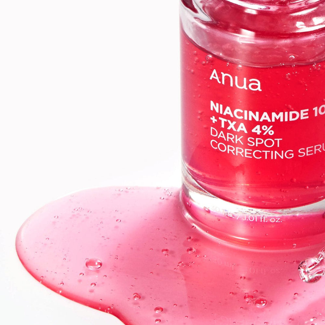 Pink serum bottle with visible brand name on a white background