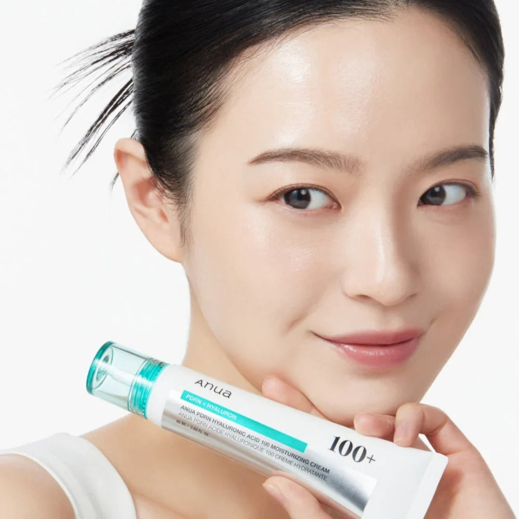 Woman holding a skincare product with a white background