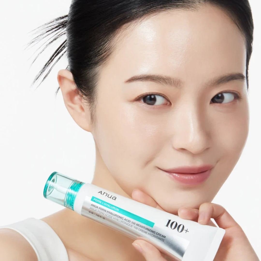 Woman holding a skincare product with a white background