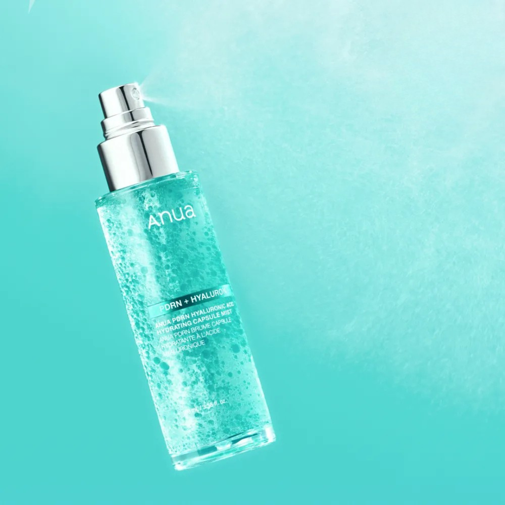 Skincare bottle with 'Anua' branding on a teal background