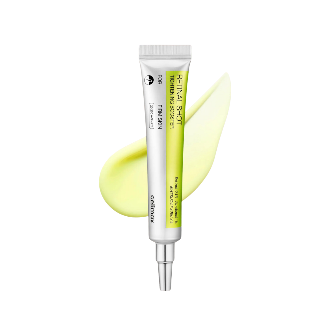 Skincare serum tube with a yellow smear on a white background