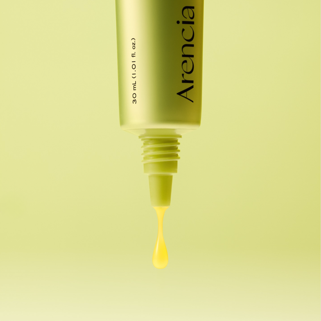Arencia dropper bottle with yellow liquid on a light green background